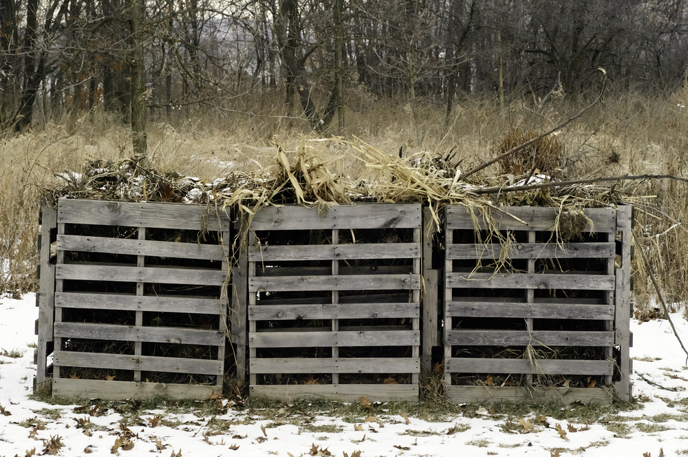 Green practice in winter Three wooden compost bins on a cold day in a public park in northern Illinois, USA