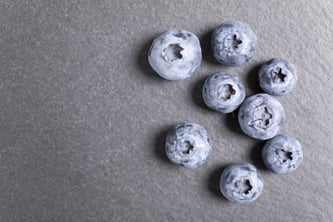 Summer ripe blueberries on black slate