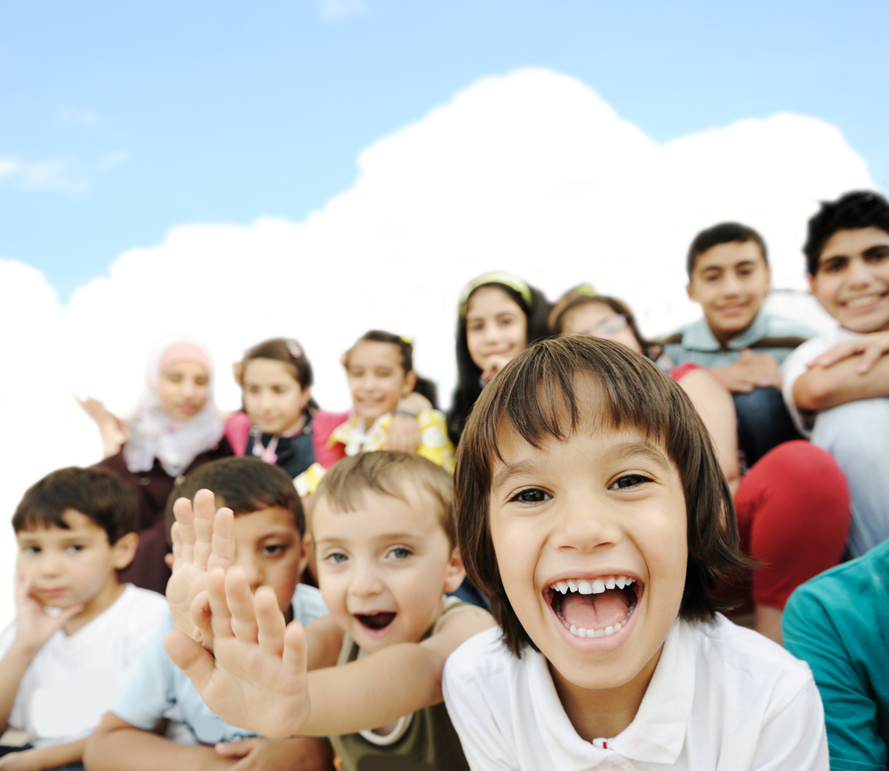 Crowd of children, sitting together happily